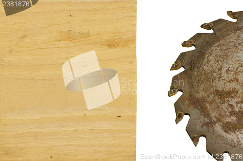 Image of circular saw disk and wood board closeup on white 