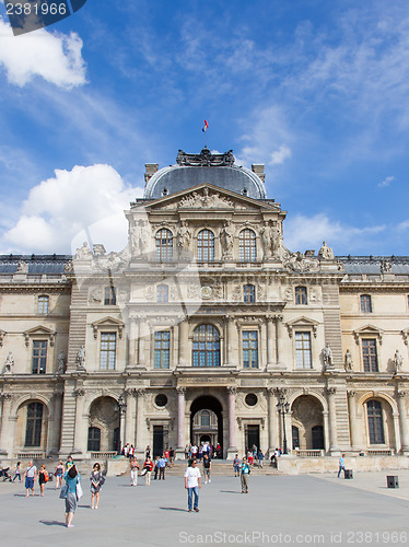 Image of PARIS - JULY 28, 2013. Tourists enjoy the weather at the Louvre 