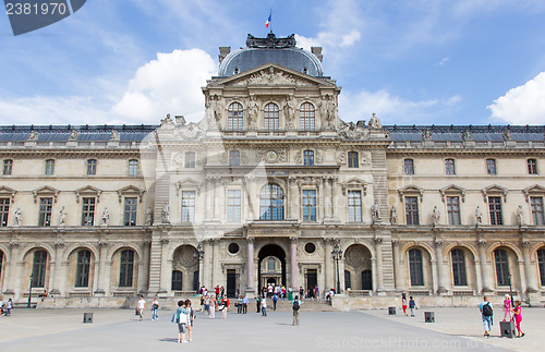 Image of PARIS - JULY 28, 2013. Tourists enjoy the weather at the Louvre 