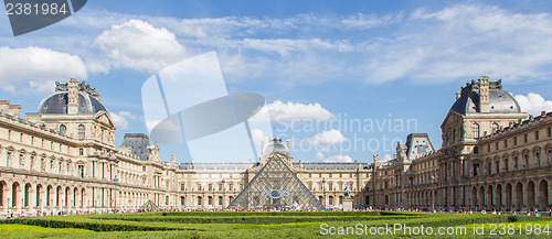 Image of PARIS - JULY 28, 2013. Tourists enjoy the weather at the Louvre 