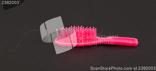 Image of Pink toy brush with hair