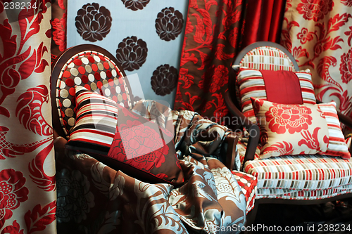 Image of Luxurious red chairs with satin pillows