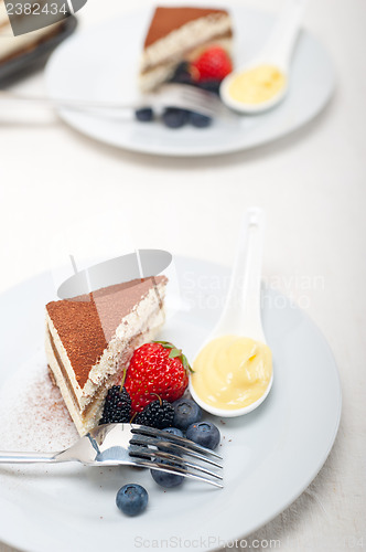 Image of tiramisu dessert with berries and cream