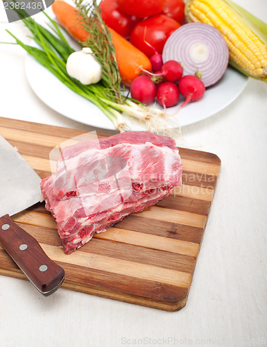 Image of chopping fresh pork ribs and vegetables