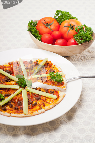 Image of Turkish beef pizza with cucumber on top