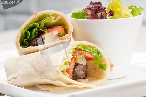 Image of kafta shawarma chicken pita wrap roll sandwich