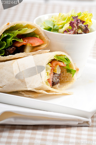 Image of kafta shawarma chicken pita wrap roll sandwich