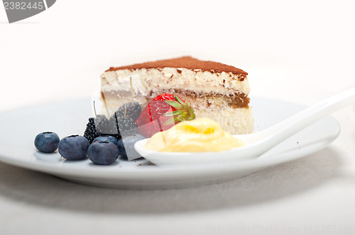 Image of tiramisu dessert with berries and cream