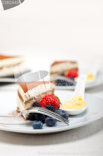 Image of tiramisu dessert with berries and cream