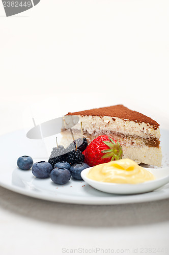 Image of tiramisu dessert with berries and cream