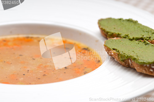 Image of Italian minestrone soup with pesto crostini on side