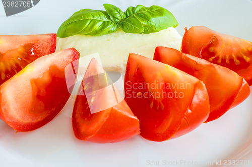 Image of Italian appetizer tomatoes with mozarella and basil