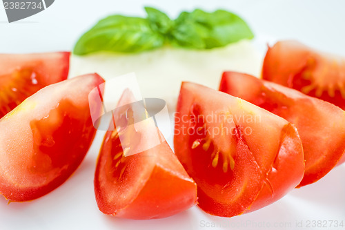Image of Italian appetizer tomatoes with mozarella and basil