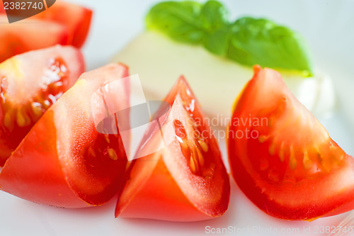 Image of Italian appetizer tomatoes with mozarella and basil