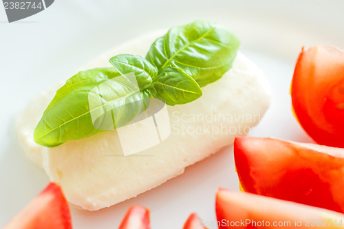 Image of Italian appetizer tomatoes with mozarella and basil