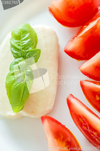 Image of Italian appetizer tomatoes with mozarella and basil