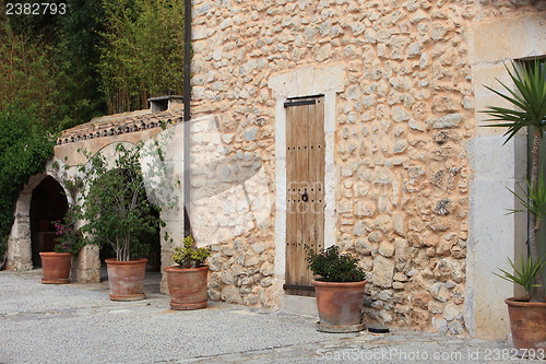 Image of Old stone building with potted plants