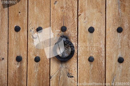 Image of Door handle or kncker on an old wooden door