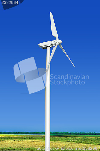 Image of green meadow with wind turbine