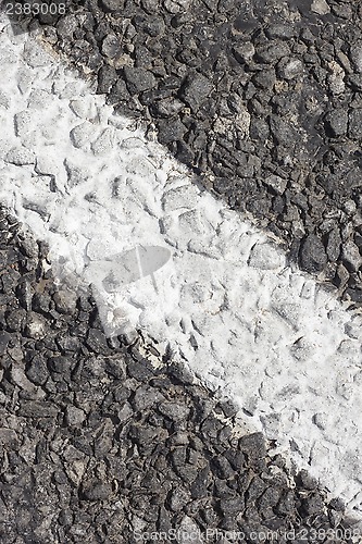 Image of Asphalt pavement with white marking strip