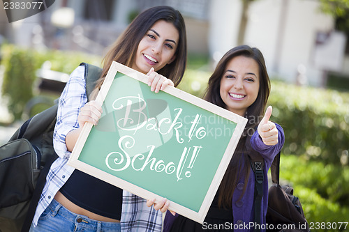 Image of Mixed Race Female Students Holding Chalkboard With Back To Schoo