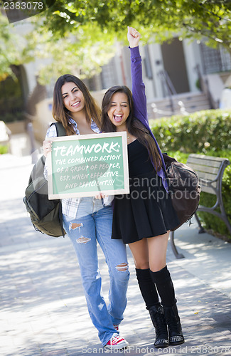 Image of Mixed Race Female Students Holding Chalkboard With Teamwork and 