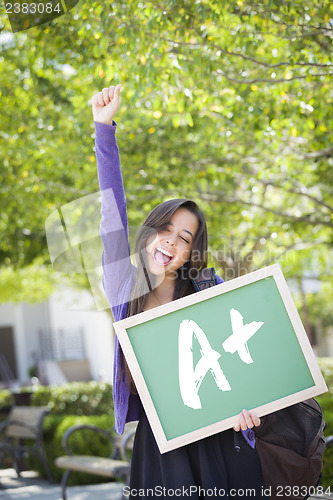 Image of Mixed Race Female Student Holding Chalkboard With A+ Written