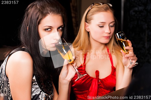 Image of beautiful women with red wine glasses