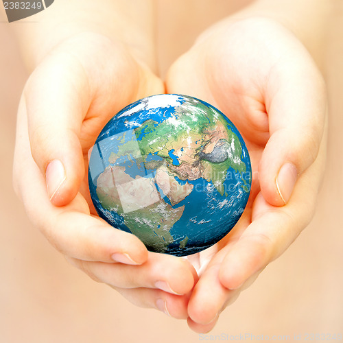 Image of Hand of the person holds globe.