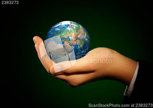 Image of Hand of the person holds globe.