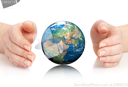 Image of Hand of the person holds globe.