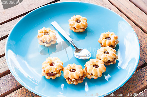 Image of Smiling face of pineapple cookies on light blue dish
