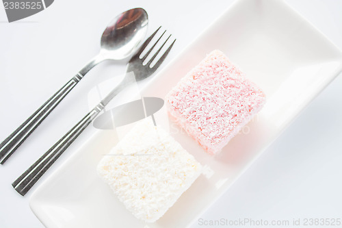 Image of Set of pink and white lamington sponge cakes 