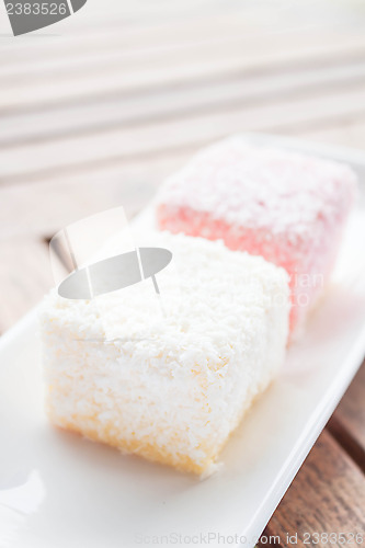 Image of Pink and white lamington cakes on wood table