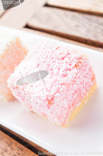 Image of Pink lamington cakes up close on wood table