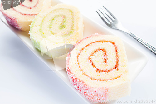 Image of Set of colorful jam roll cakes with fork