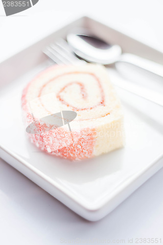 Image of Sweet dish of pink jam roll cake