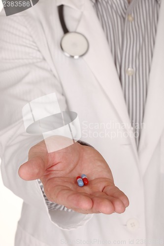 Image of Caucasian Doctor With Medication in Hand Reaching Out