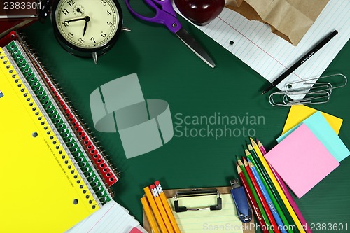 Image of Back to School Items Arranged on a Green Blackboard