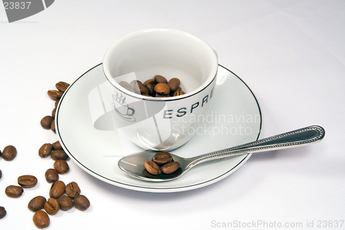 Image of Tight closeup of espresso cup and saucer with beans