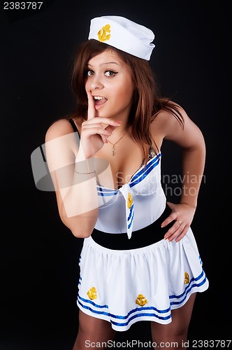 Image of Young beautiful sailor woman with finger on lips