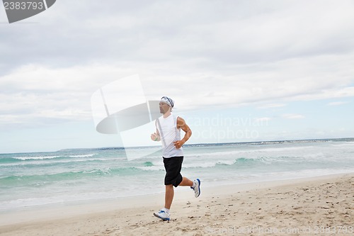 Image of man is jogging on the beach summertime sport fitness