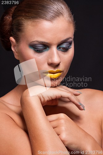 Image of woman with extreme colorfull make up in blue and yellow