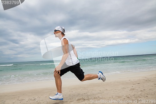 Image of man is jogging on the beach summertime sport fitness