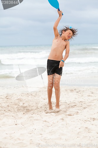Image of happy little child kid boy  playing beachball on beach in summer 