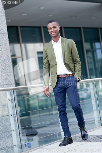 Image of young successful african business man outdoor in summer
