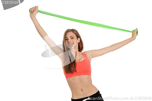 Image of athletic young woman doing workout with physio tape latex tape