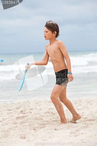 Image of happy little child kid boy  playing beachball on beach in summer 