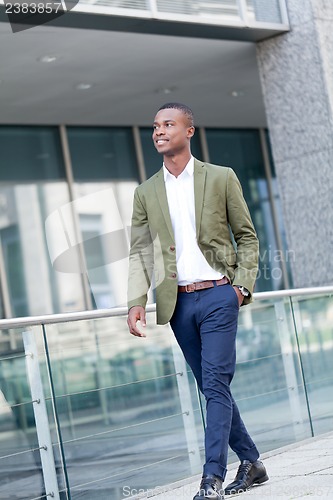 Image of young successful african business man outdoor in summer