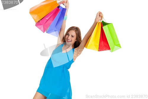 Image of attractive young woman with colorful shopping bags isolated